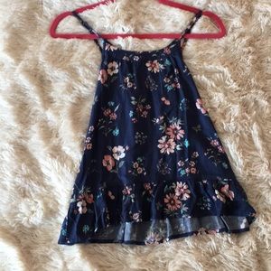 Blue blouse with cross straps in back.